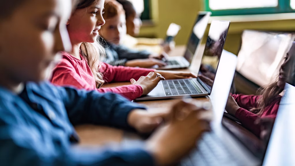 Students learning on laptops in a classroom